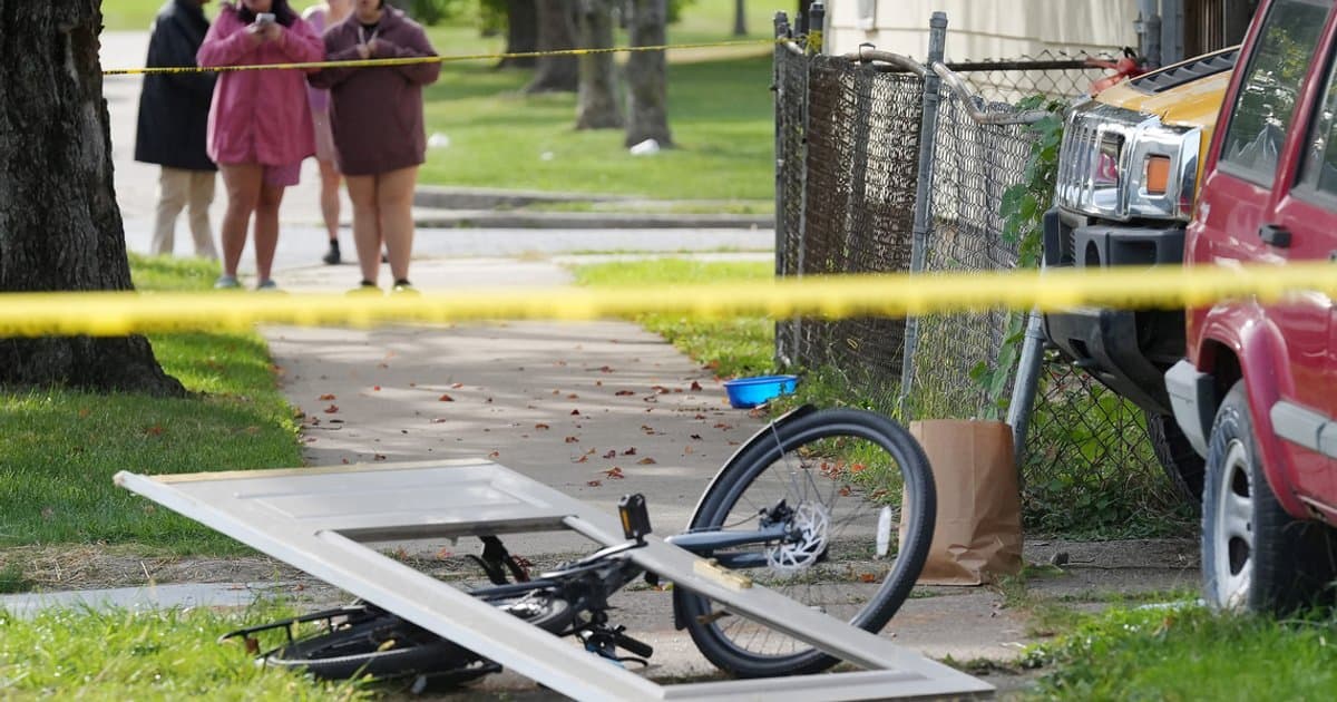 Bystanders gather behind police tape near the house in Erie, Pennsylvania, where the shooting took place.
