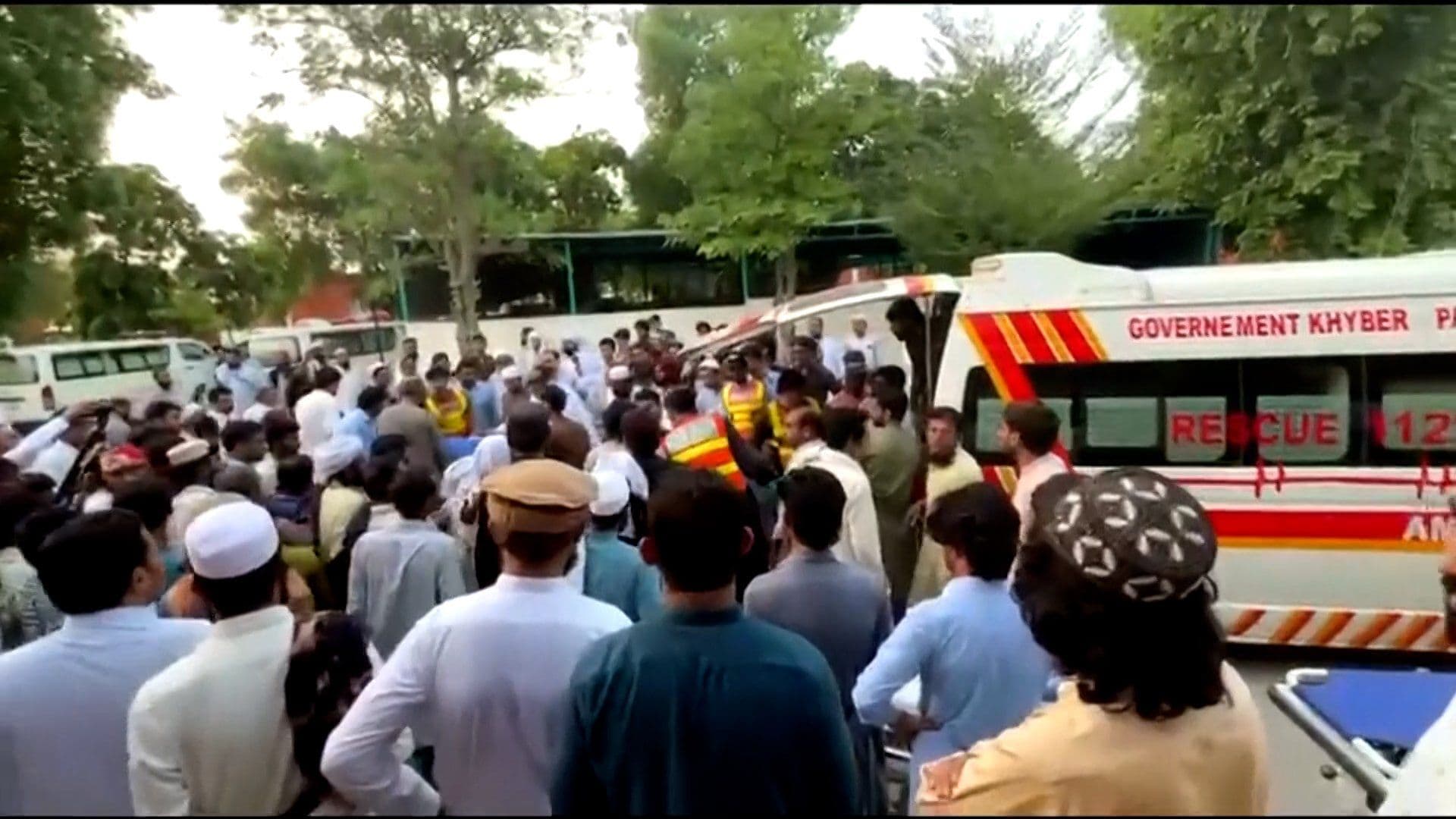 People gather near a Khyber Pakhtunkhwa rescue ambulance, from Al Jazeera’s report on the suicide bombing in northwest Pakistan.