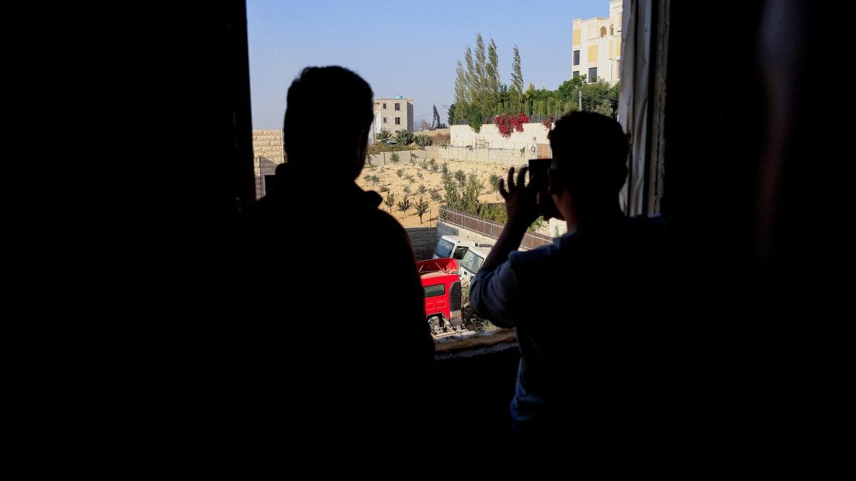 Palestinians watch as Israeli machinery demolishes a Palestinian house following the shooting attack, in Hebron in the occupied West Bank, on 23 October 2026.