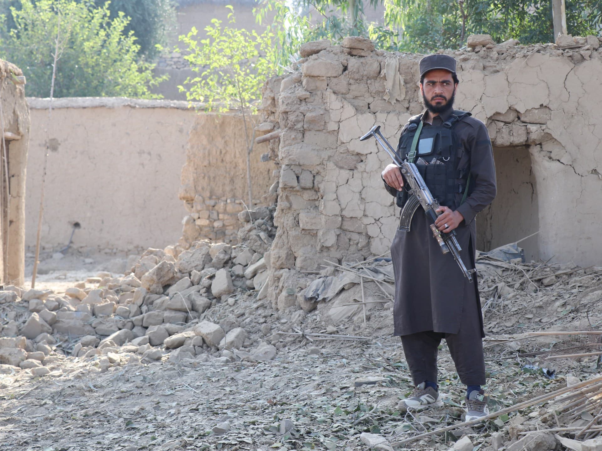 A Taliban security personnel stands guard near a damaged house, after Pakistani airstrike struck Gurbuz district in Afghanistan's Khost province on September 24, 2026.