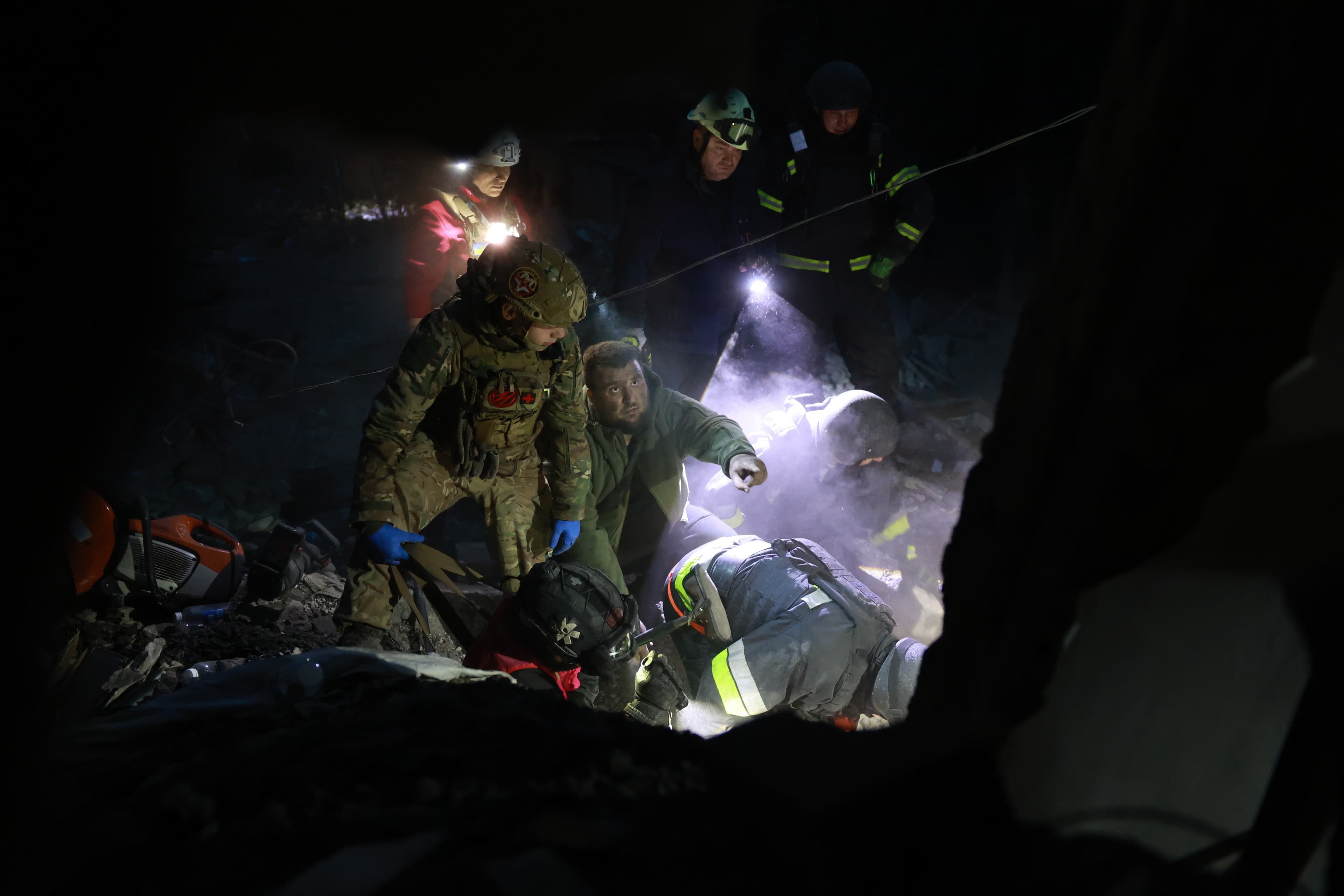 Rescue workers clear the rubble of a residential building destroyed by a Russian airstrike in Zaporizhzhia, Ukraine, on 10 October.