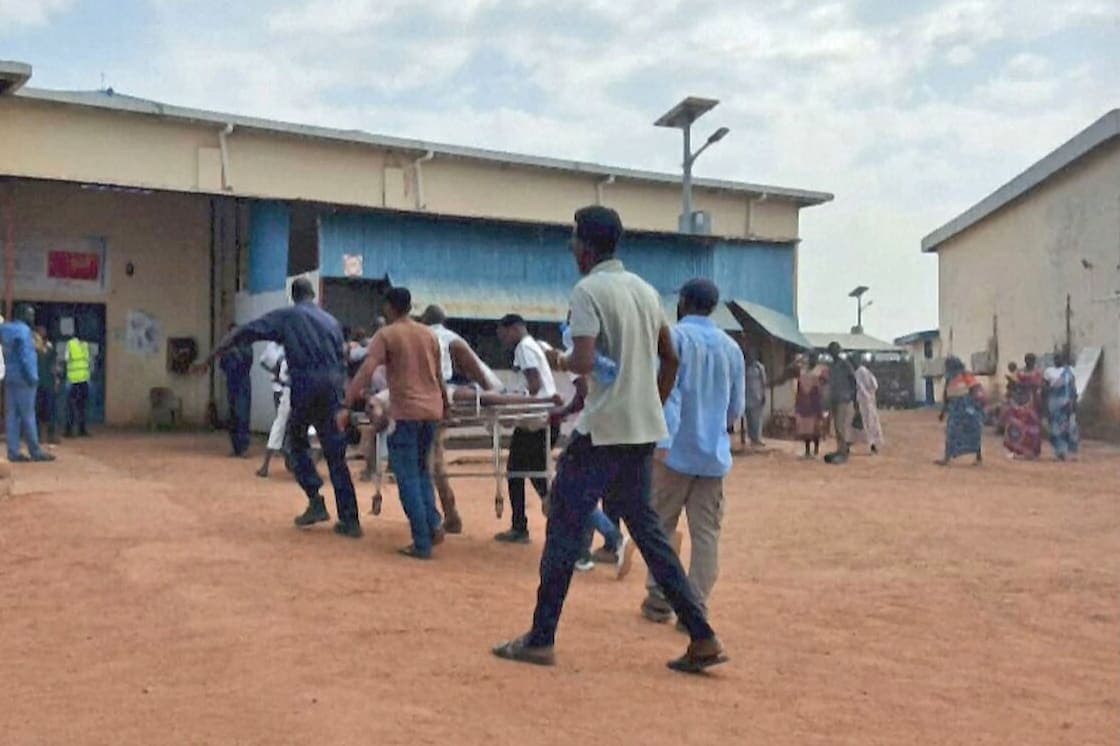 Men carry one of the injured after the drone attack in the Abyei region, 19 October.