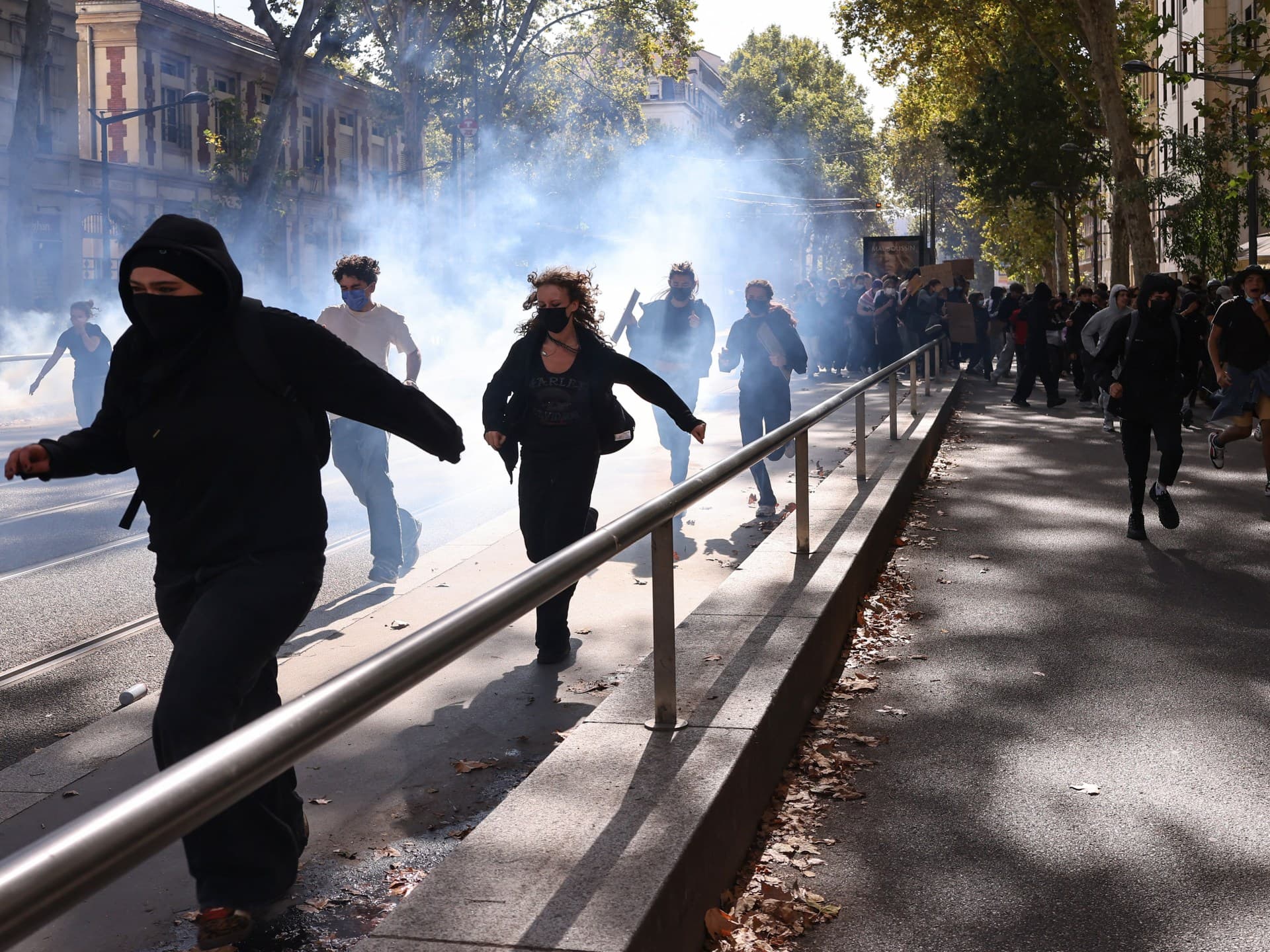 Protesters run from tear gas during student demonstrations in Lyon, eastern France, on October 2, 2026.