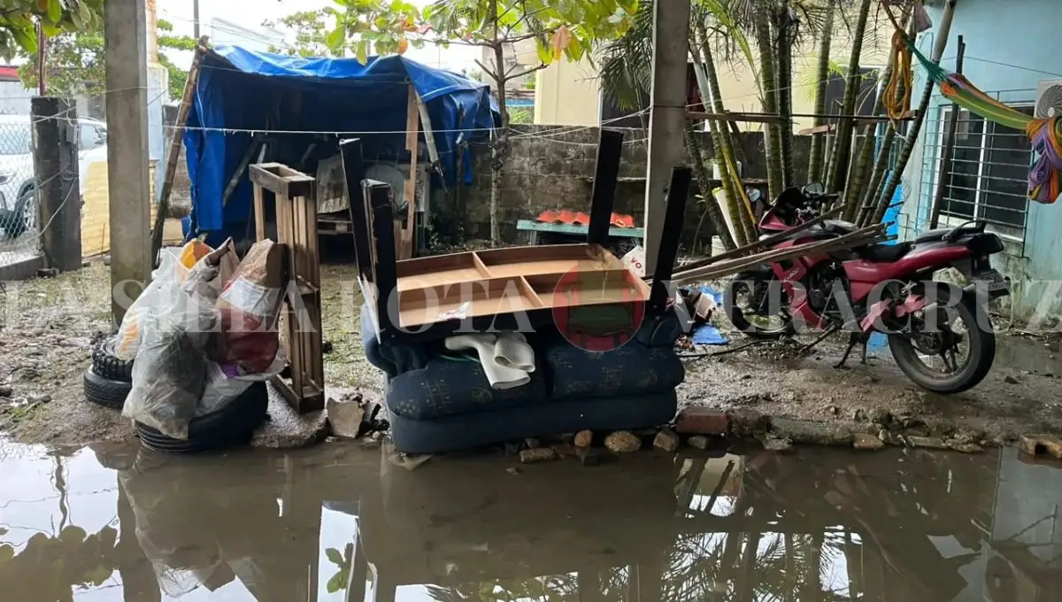 Belongings soaked by floodwater outside a home in Nanchital, Veracruz, after the cold-front floods of October 2026.