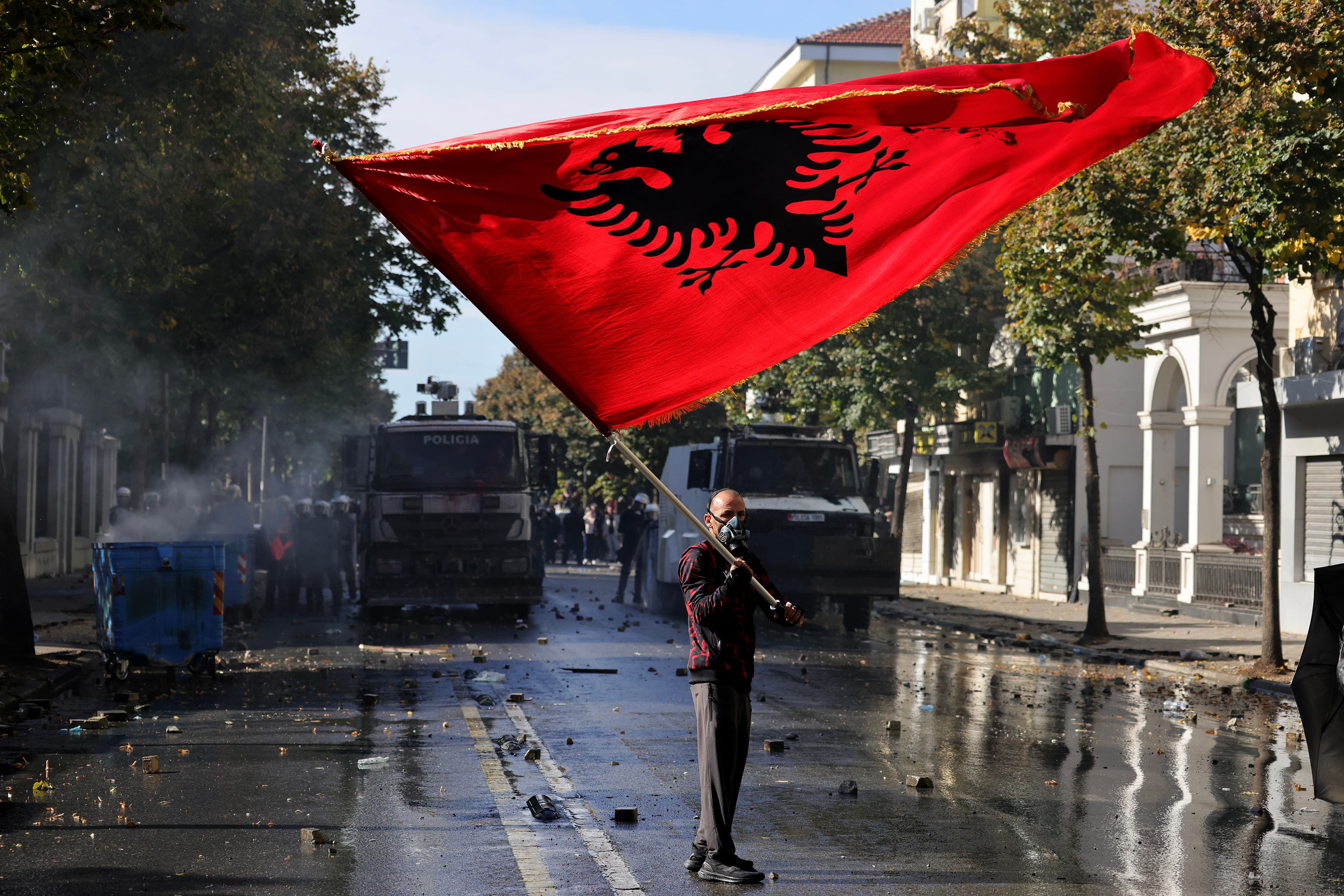 A protester waves an Albanian flag during an anti-government demonstration outside the Education Ministry in Tirana on 17 October.