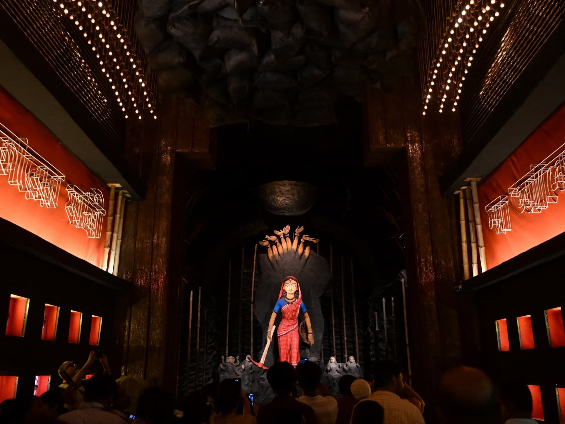 File photograph: Devotees photograph an idol of the goddess Durga at a pandal in Kolkata during the Durga Puja festival, on 16 October, the day before the crush (file photo).