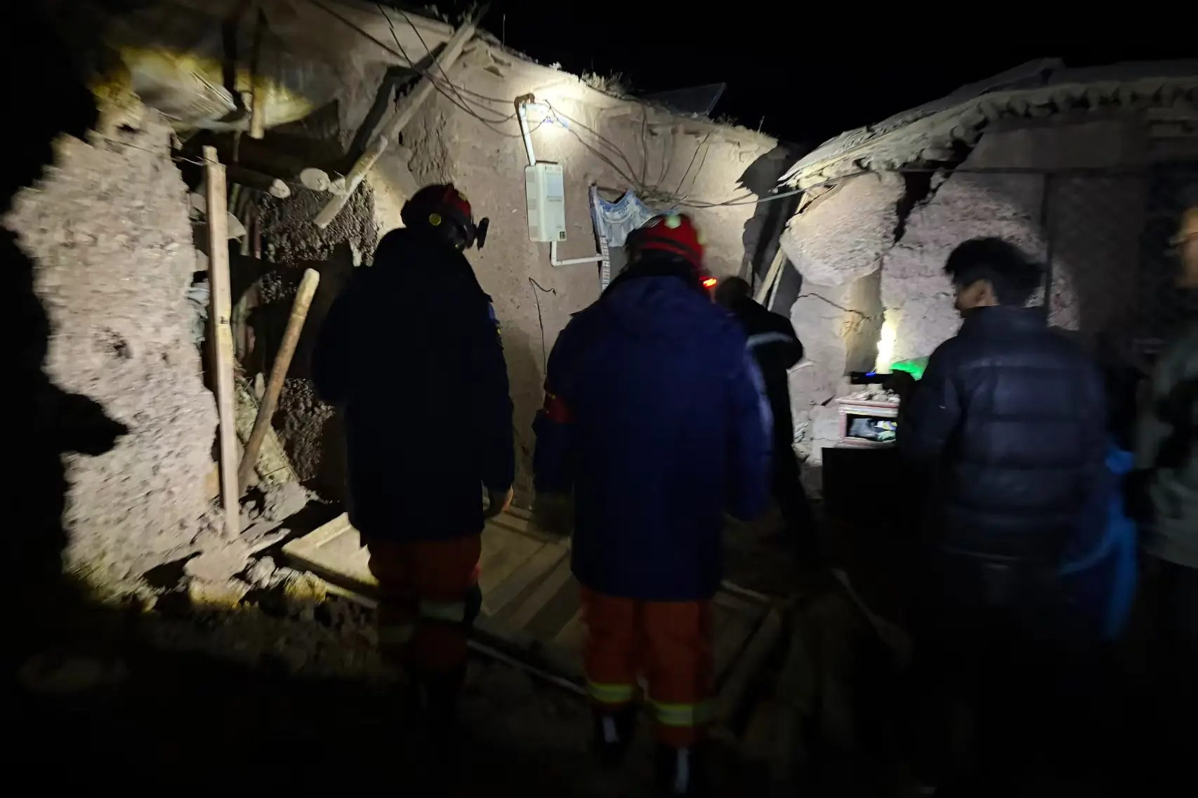 Firefighters inspect earthquake-hit village houses in Baqen County, Nagqu, Tibet, on 23 October 2026.